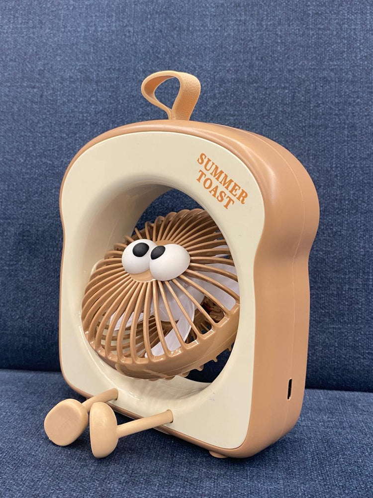 The item in the image is a "Summer Toast" mini portable fan, designed with an adorable toast shape and googly eyes.
