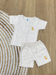 The item in the image is an (Magic train)Unisex Cotton Plain Baby Short Sleeves Suit & Short Pants. The small logo on both the shirt and shorts is a dog.