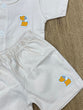 The item in the image is an (Magic train)Unisex Cotton Plain Baby Short Sleeves Suit & Short Pants. The small logo on both the shirt and shorts is a dog.