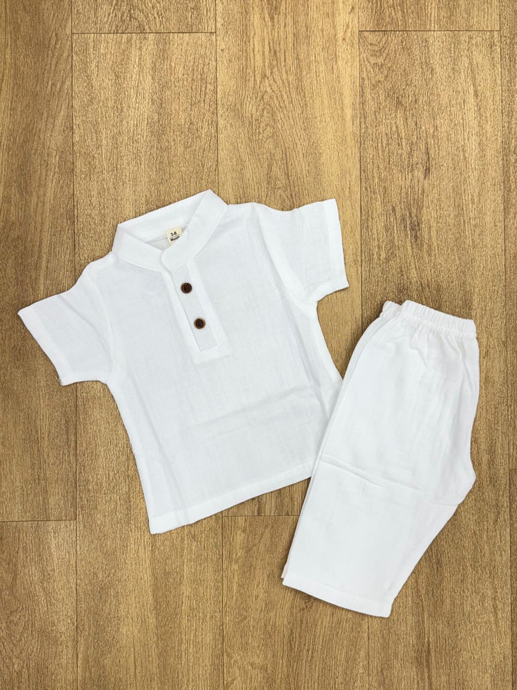 This image features is beige muslin co-ord set, consisting of a short-sleeve shirt and matching shorts.