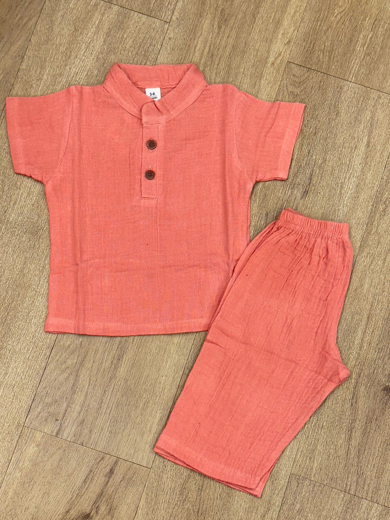 This image features is beige muslin co-ord set, consisting of a short-sleeve shirt and matching shorts.