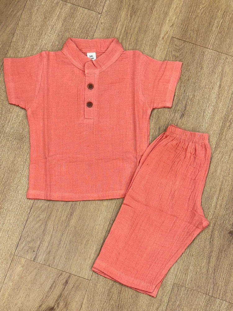 This image features is beige muslin co-ord set, consisting of a short-sleeve shirt and matching shorts.