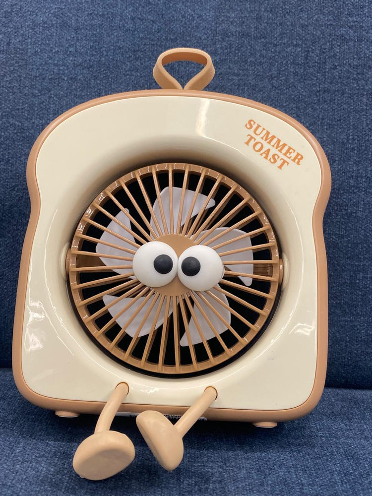 The item in the image is a "Summer Toast" mini portable fan, designed with an adorable toast shape and googly eyes.